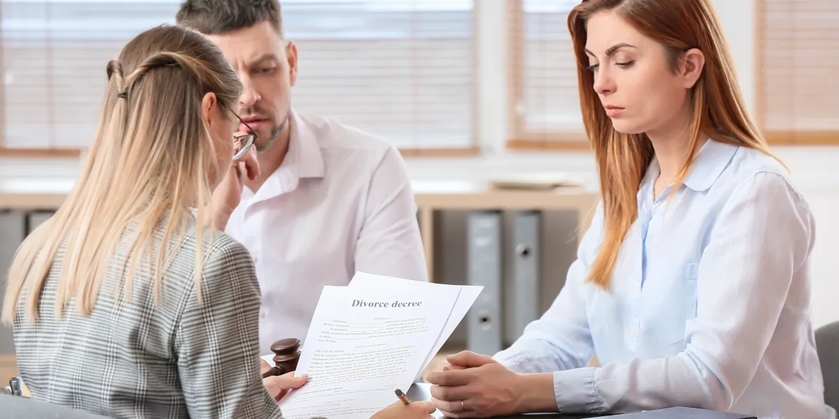 Couple meeting with a lawyer reviewing a divorce decree